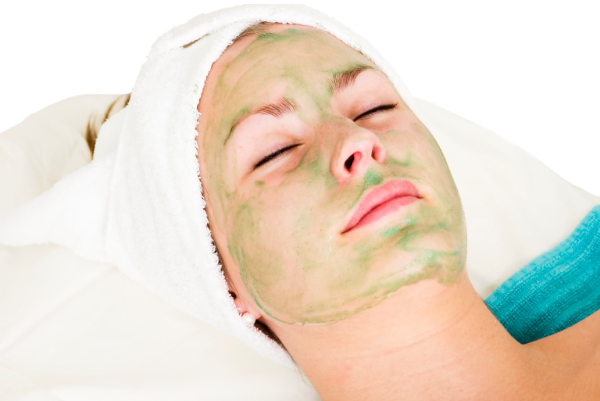 Woman treating her face with aloe vera facial mask