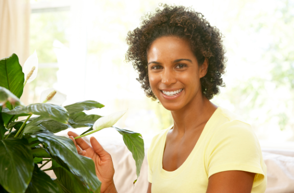 Woman looking after houseplant